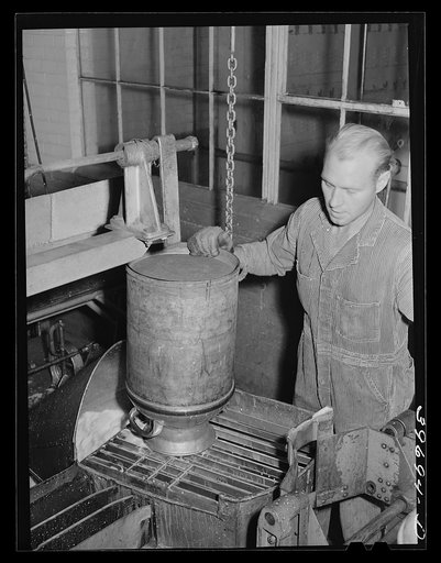 Untitled photo, possibly related to: Dumping milk into container where it will be weighted and the weight automatically recorded at the Dairymen's Cooperative Creamery. Caldwell Canyon, Idaho