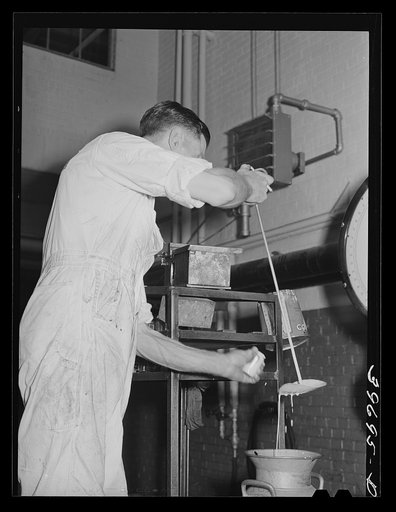 Taking a sample of milk to determine butter fat content. Dairymen's Cooperative Creamery. Caldwell, Canyon County, Idaho