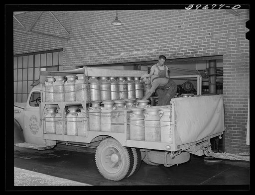 Truckload of milk-filled cans arrive at the Dairymen's Cooperative Creamery. Caldwell, Canyon County, Idaho