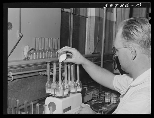 Taking samples for Babcock test for butterfat at the Dairymen's Cooperative Creamery. Caldwell, Canyon County, Idaho