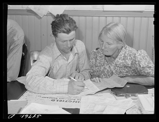 FSA (Farm Security Administration) clients preparing farm plan in county supervisor's office. Grangeville, Idaho