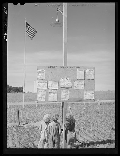 Children at the farm activities bulletin board at the FSA (Farm Security Administration) migratory farm labor camp mobile unit. Athena, Oregon