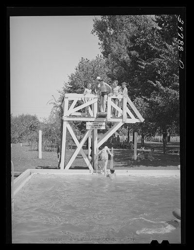 Untitled photo, possibly related to: Children from the FSA (Farm Security Administration) migratory farm labor camp mobile unit swim in the town swimming pool of Athena, Oregon