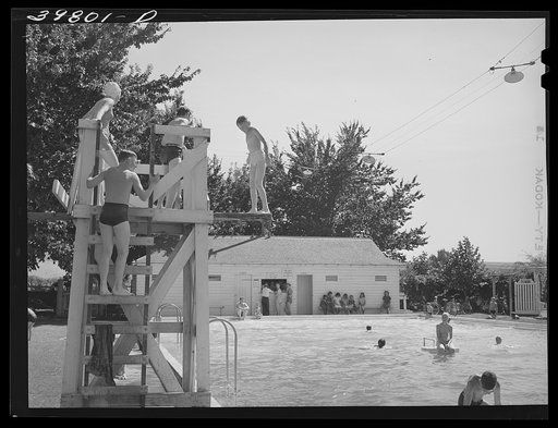 Children from the FSA (Farm Security Administration) migratory farm labor camp mobile unit swim in the town swimming pool of Athena, Oregon