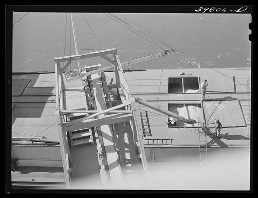 Untitled photo, possibly related to: Pouring wheat into hole of barge at Port Kelly, Walla Walla County, Washington