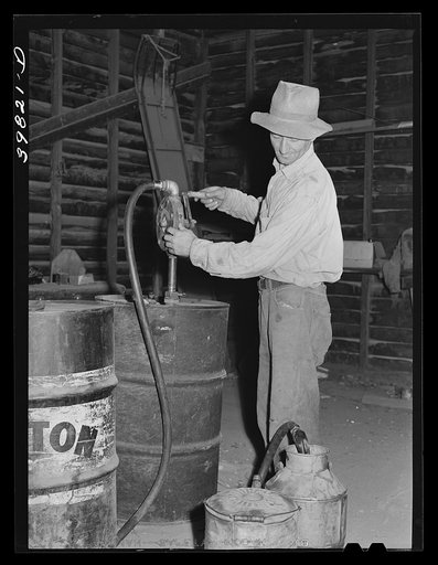 Getting gasoline from barrel at farm to take out to combine in the wheat field. Walla Walla County, Washington