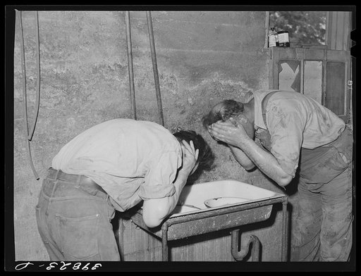 Harvest hands wash up for dinner (noon). Wheat farm, Walla Walla County, Washington
