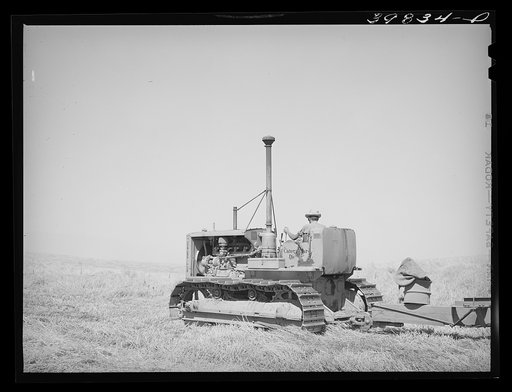 Caterpillar diesel tractor which draws combine in wheat fields on Eureka Flats. Walla Walla County, Washington