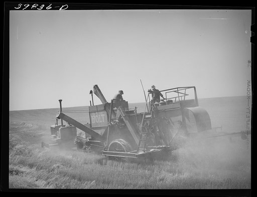 Untitled photo, possibly related to: Tractor-drawn combine in wheat field on Eureka Flats. Walla Walla County, Washington