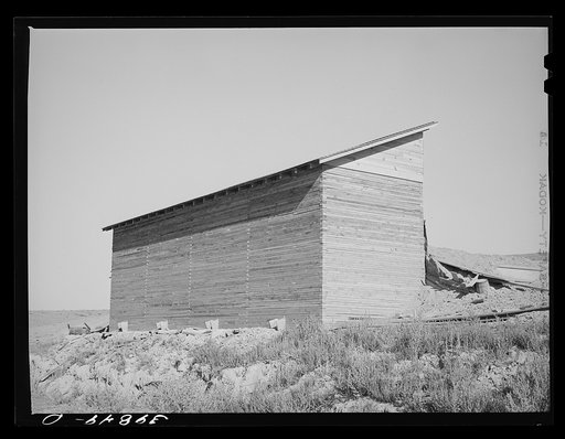 Untitled photo, possibly related to: Bulk wheat elevator on farm. This elevator was built from plans drawn up and furnished by the State Extension Service and AAA (Agricultural Adjustment Administration). These farm elevators are designed to take care of the bumper crop of wheat this year for which 