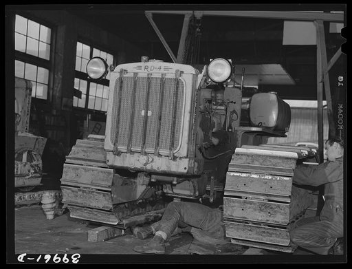 Caterpillar tractor in repair shop at Colfax, Washington. These tractors are used in the wheat lands