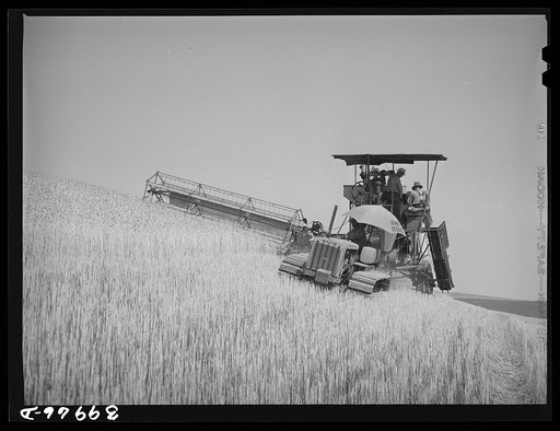 Untitled photo, possibly related to: Caterpillar-drawn combine working in wheat fields. Whitman County, Washington