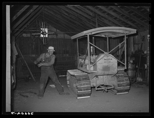 Wheat farmer starts his caterpillar tractor with aid of rope. Whitman County, Washington