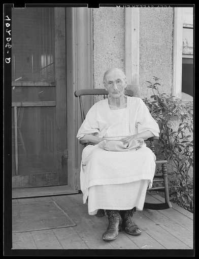 Barto, Berks County, Pennsylvania. Mrs. Springer, Mrs. Evans grandmother, on the front porch, on the farm of Thomas G. Evans, a FSA (Farm Security Administration) client