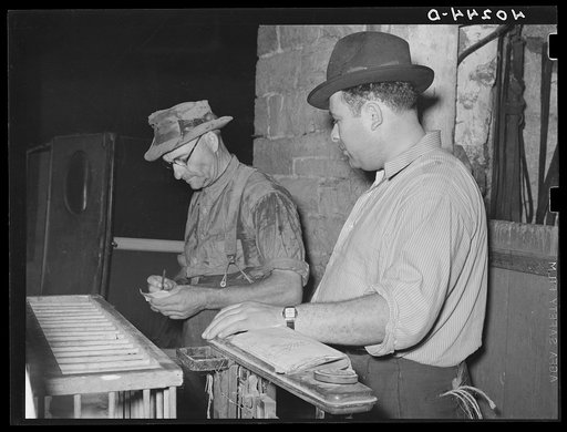 Lancaster County, Pennsylvania. Enos Royer and the poultry buyer figuring the cost of chickens by weight. The chickens brought 14 1/2 cents per pound