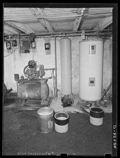 Lancaster County, Pennsylvania. The second pressure pump in the cellar of the house on the Enos Royer farm. The family's milk supply is stored here