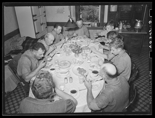 Lancaster County, Pennsylvania. Enos and Herbert Royer and the farm hands having dinner on the farm of Enos Royer. Three of the men are his hired hands, and the rest have come to help fill the silo