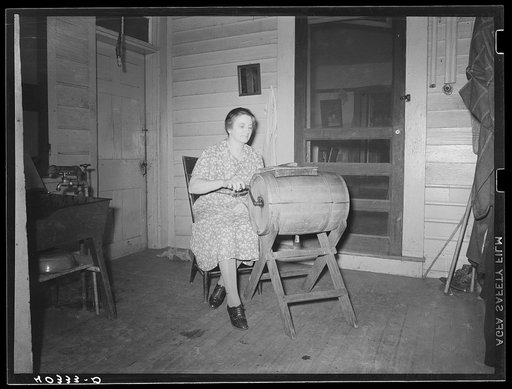 Lancaster County, Pennsylvania. Mrs. Royer churning butter on the back porch of the Enos Royer farm