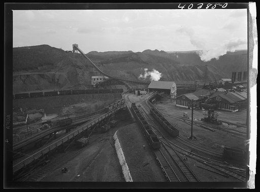 Shenandoah (vicinity), Pennsylvania. Tracks at the Maple Hill mine leading to the crusher and to the Saint Nicholas breaker at Gilberton. The rock dump is on the top of a rock-dirt hill. View from shaft tower