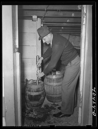 Shenandoah, Pennsylvania. Mike ("Mitzi") Karachuta filling glasses at a beer party in Joe Gladski's cellar