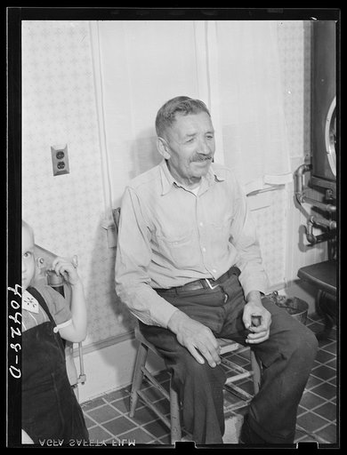 Untitled photo, possibly related to: Shenandoah, Pennsylvania. Joe Gladski's father and two small daughters. An electric washing machine appears in the left-hand corner of the room. Joe is a miner at Maple Hill