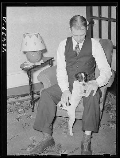 Shenandoah, Pennsylvania. Al Banonia, playing with a little dog at his house