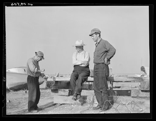 Deal Island fisherman. Man on left is opening an oyster. Eastern Shore, Maryland