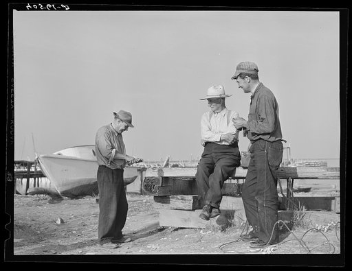 Untitled photo, possibly related to: Deal Island fisherman. Man on left is opening an oyster. Eastern Shore, Maryland