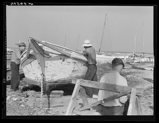 Untitled photo, possibly related to: Fisherman watching boat being repaired. Eastern Shore Maryland