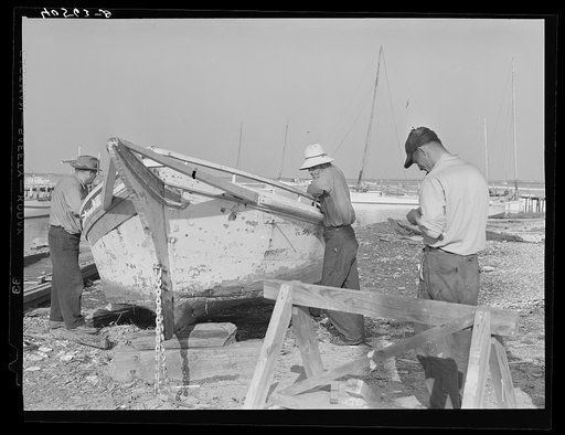 Fisherman watching boat being repaired. Eastern Shore Maryland