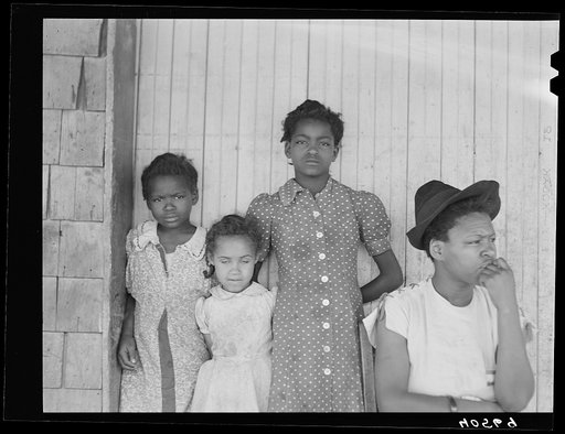 Untitled photo, possibly related to: Some of the people living in an old garage converted into a dwelling. Outskirts of Graham, Alamance County, North Carolina