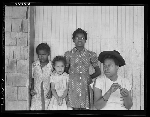 Untitled photo, possibly related to: Some of the people living in an old garage converted into a dwelling. Outskirts of Graham, Alamance County, North Carolina