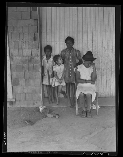 Untitled photo, possibly related to: Some of the people living in an old garage converted into a dwelling. Outskirts of Graham, Alamance County, North Carolina