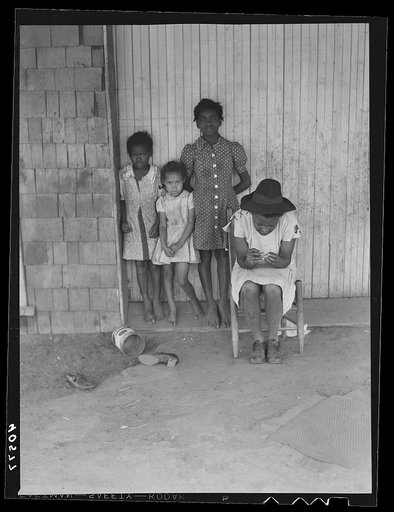 Some of the people living in an old garage converted into a dwelling. Outskirts of Graham, Alamance County, North Carolina
