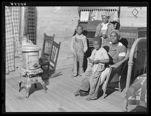 Wife and children of Mr. Hubbard, Negro tenant farmer, planting tobacco. Near Farrington, Chatham County, North Carolina