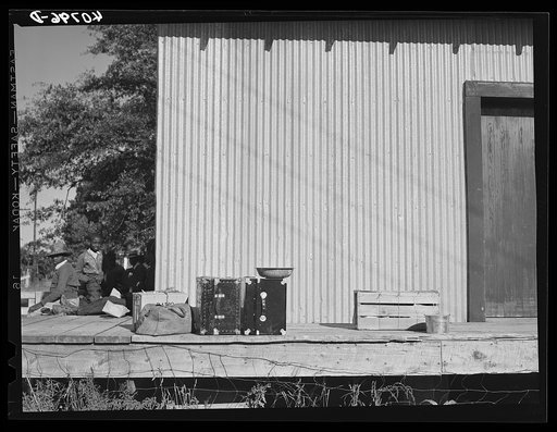 Untitled photo, possibly related to: Warehouse that provides housing for a number of migratory agricultural workers. On the left is the baggage of some of the new arrivals. Camden, North Carolina