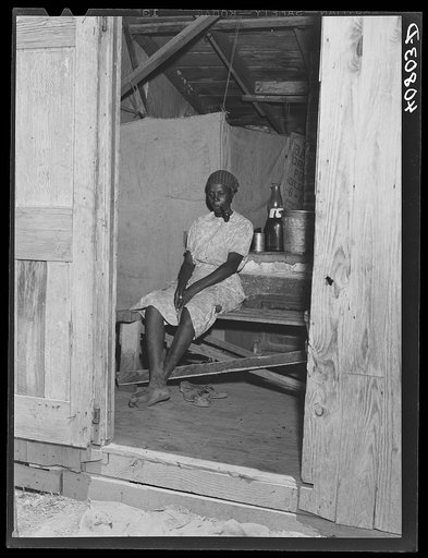 Migratory agricultural worker in her shack where she lives with eleven others. Belcross, North Carolina