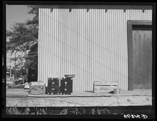 Untitled photo, possibly related to: Warehouse that provides housing for a number of migratory agricultural workers. On the left is the baggage of some of the new arrivals. Camden, North Carolina