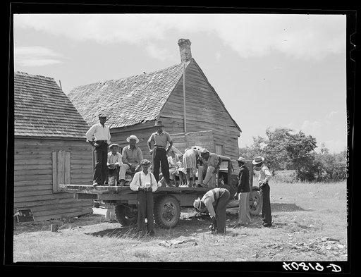 Part of a crew of thirty-five migrants who come up in this truck and who stay in the farmhouse in background. It is Sunday and they are going into town for the day