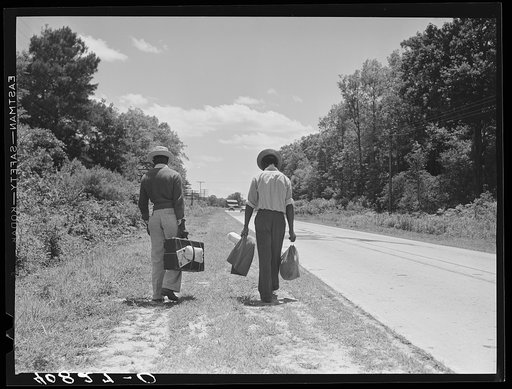 Migratory agricultural workers on Route 27 trying to "hitch" north with the potato season. North Carolina