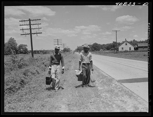 Migratory agricultural workers on Route 27 trying to "hitch" north with the potato season. North Carolina