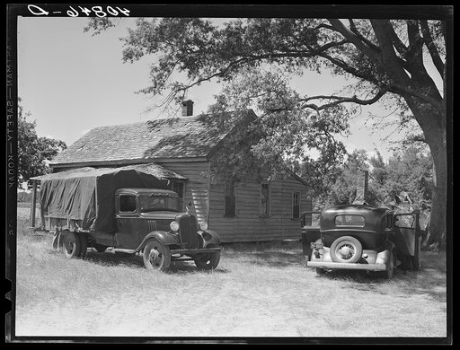 Florida migrants' truck and car outside of farmhouse that houses thirty-seven of them. Old Trap, North Carolina