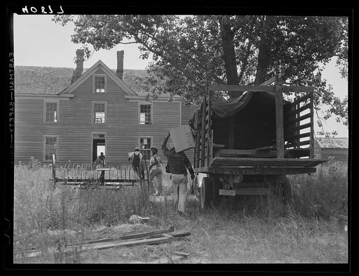 Florida migratory agricultural workers arrive at their new home near Onley, Virginia. There is no store at this place and the only drinking water is at the next farm