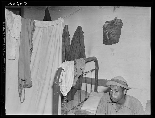 In one of the rooms of house holding thirty persons called the "bullpen" at a camp of migratory agricultural workers at Staytonville, Delaware. The single sheet on a line separates this from the next