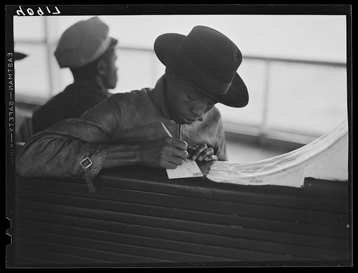 Untitled photo, possibly related to: Migratory worker on the Norfolk-Cape Charles Ferry, writing a postcard home to his parents