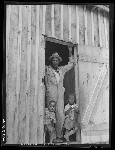 Father and two of his children at a migrants' camp at Staytonville, Delaware