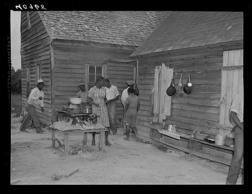 Untitled photo, possibly related to: Stove in foreground and cooking utensils in the background are used to cook for thirty-five migratory agricultural workers who stay in this camp. Near Old Trap, North Carolina