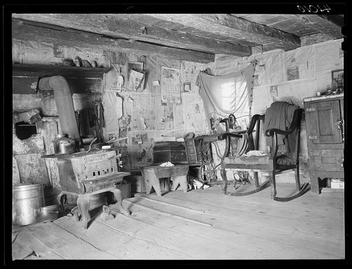 An old log cabin occupied by the family of FSA (Farm Security Administration) client George W. Green. A new house is being built directly behind this one. Saint Inigoes, Maryland