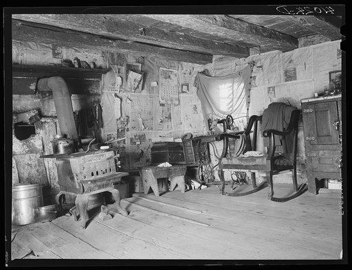 Untitled photo, possibly related to: An old log cabin occupied by the family of FSA (Farm Security Administration) client George W. Green. A new house is being built directly behind this old one. Saint Inigoes, Maryland