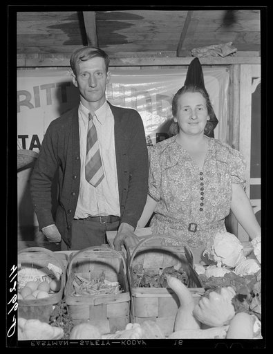 Untitled photo, possibly related to: Mr. and Mrs. Bundy at their booth at the Tri-County Farmers Co-op Market at Du Bois, Pennsylvania
